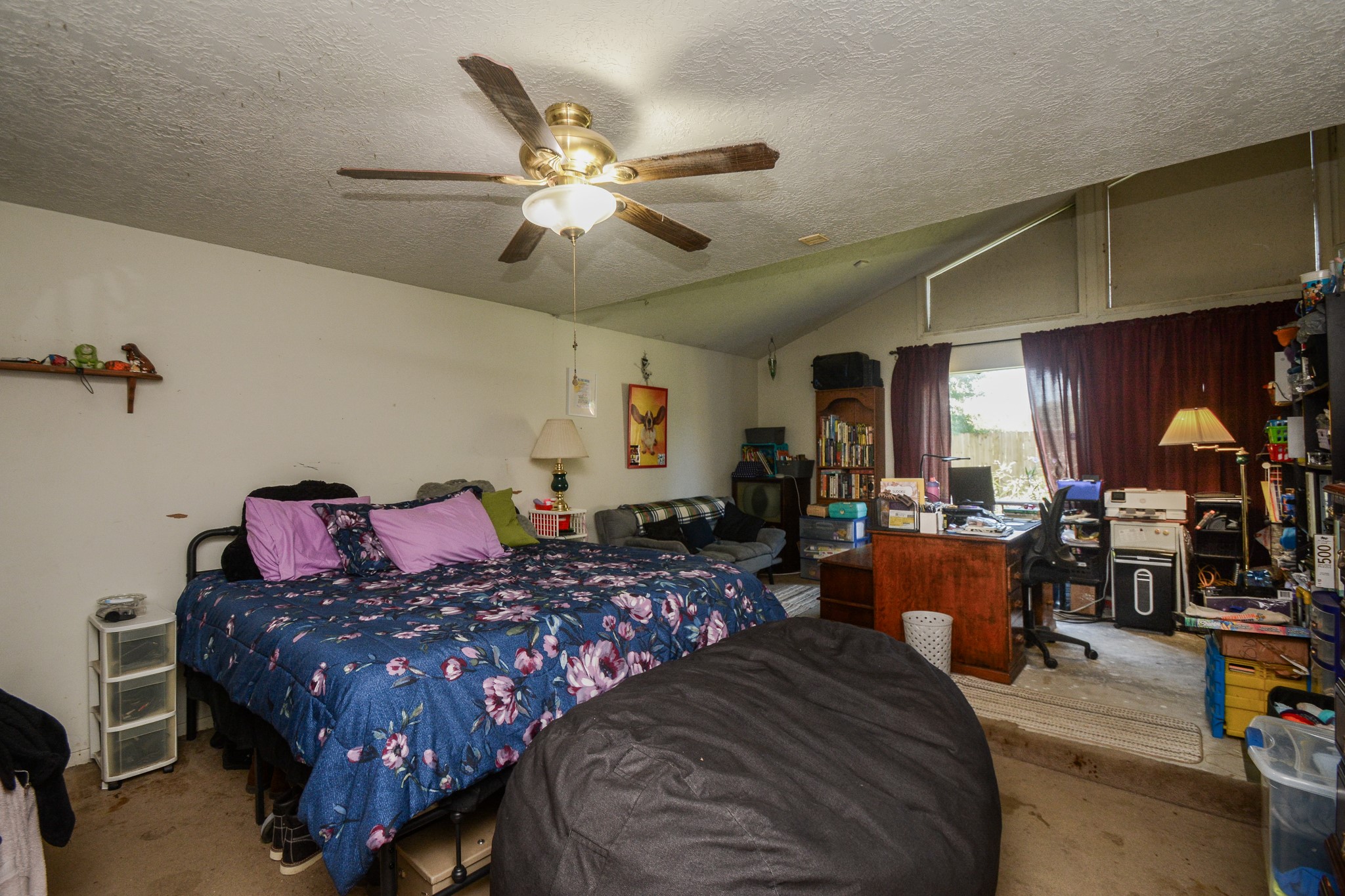 13630 Oleoke Lane Houston, TX 77015 - Photo 8 of 16 a bedroom with a bed a chandelier and a dresser