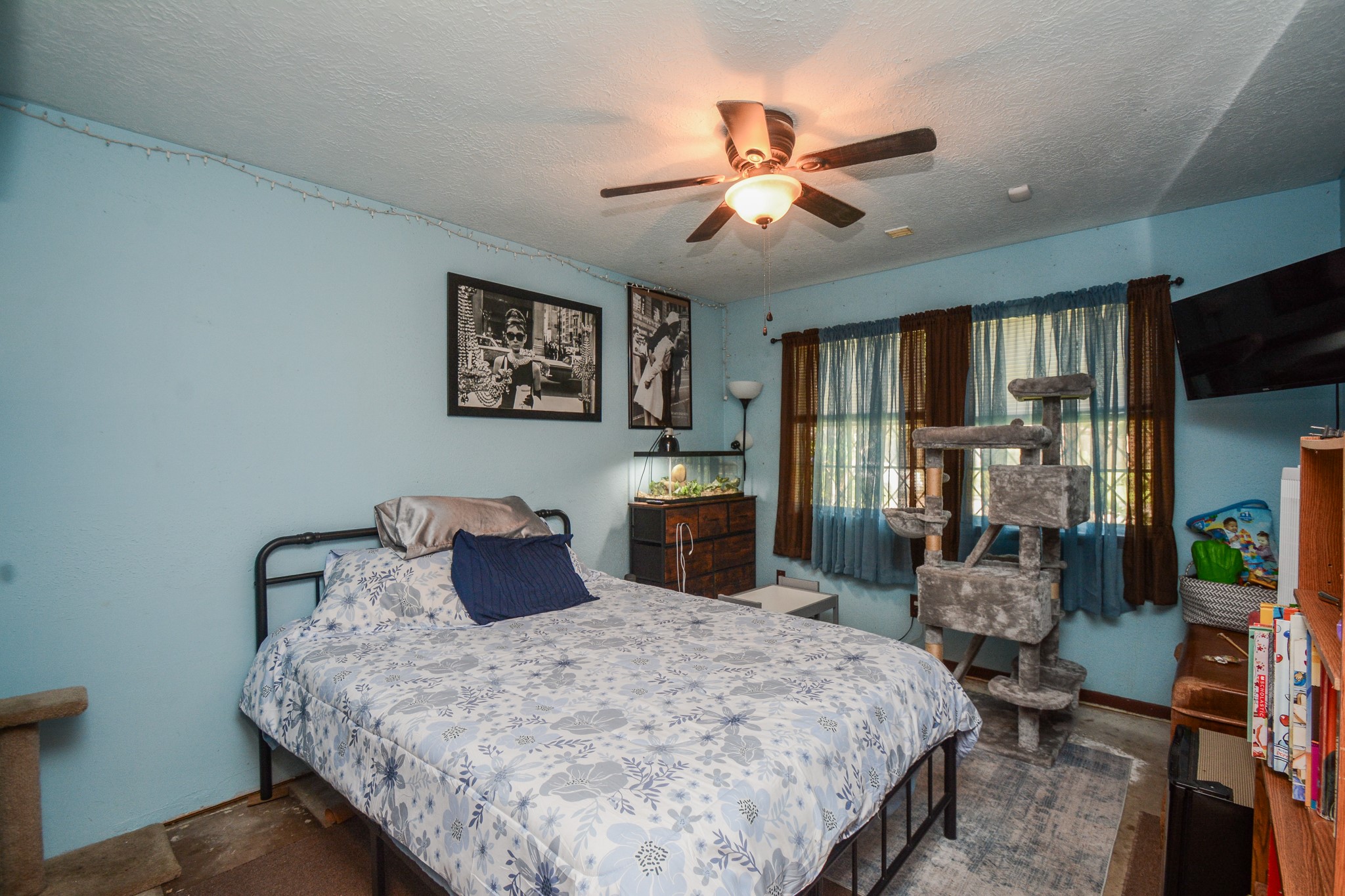 13630 Oleoke Lane Houston, TX 77015 - Photo 10 of 16 a bedroom with a large bed and a chandelier