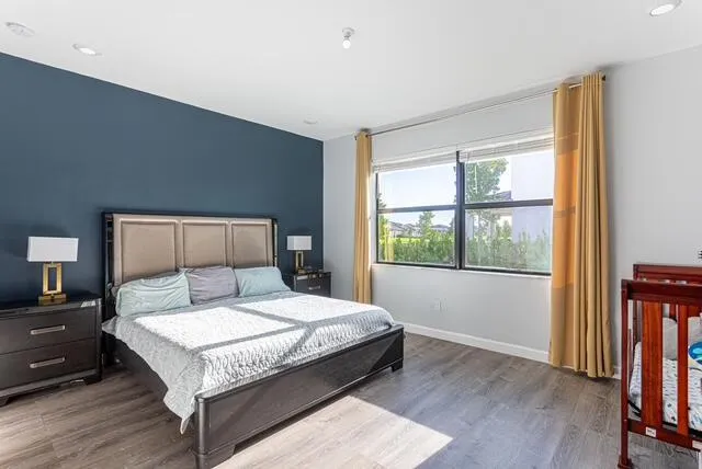 a bedroom with a large bed and a window