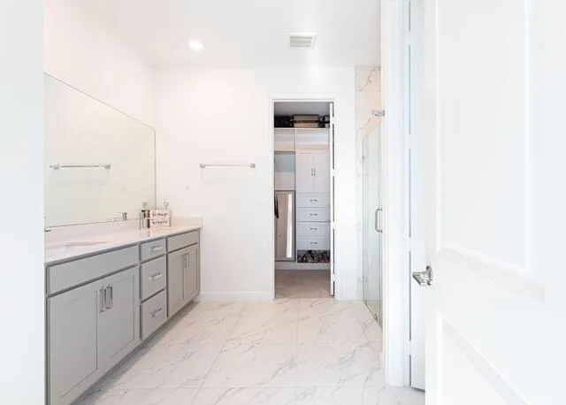 a bathroom with a double vanity sink a mirror and a shower