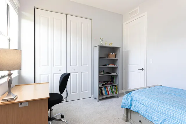 a bedroom with furniture and a wooden floor