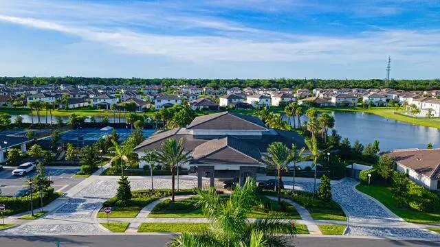 an aerial view of a house with a garden and lake view
