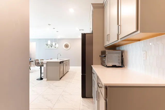 a kitchen with stainless steel appliances a microwave a sink and a refrigerator