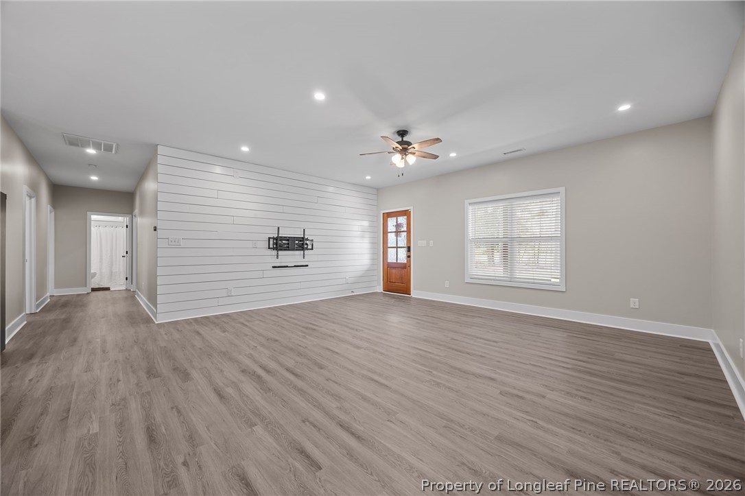 432 Pearidge Road Willow Spring, NC 27592 - Photo 14 of 47 a view of an empty room with a window and wooden floor
