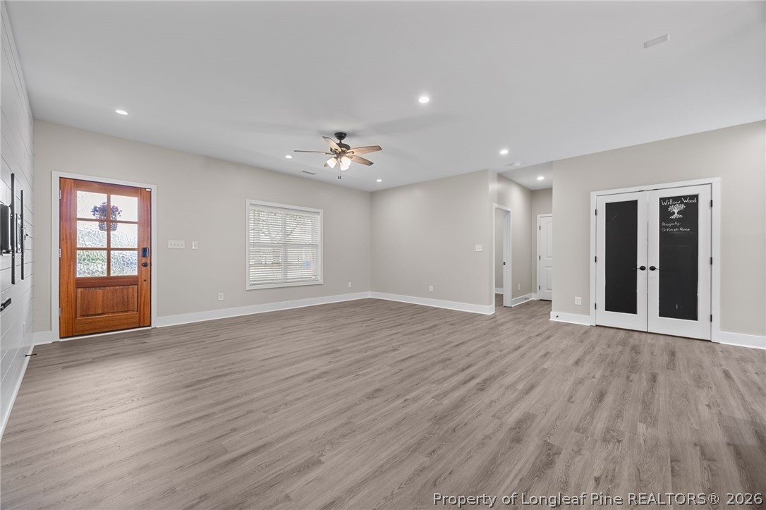432 Pearidge Road Willow Spring, NC 27592 - Photo 17 of 47 a view of an empty room with window and wooden floor