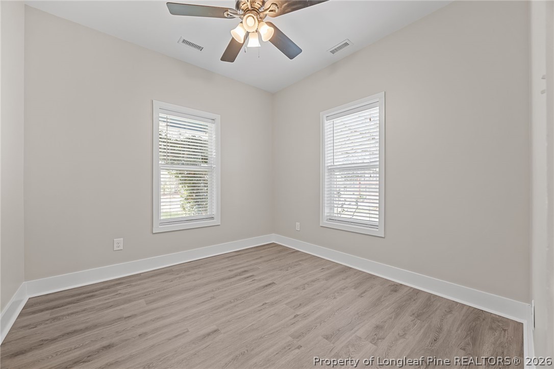432 Pearidge Road Willow Spring, NC 27592 - Photo 19 of 47 a view of an empty room with wooden floor and a window