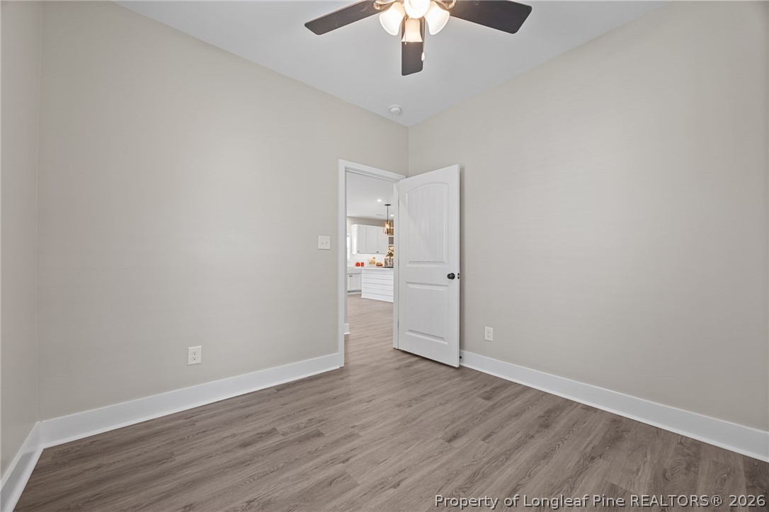 432 Pearidge Road Willow Spring, NC 27592 - Photo 20 of 47 wooden floor in an empty room with a chandelier fan