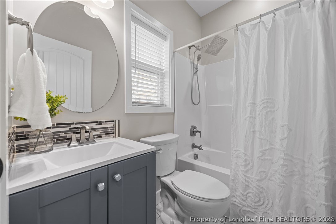 432 Pearidge Road Willow Spring, NC 27592 - Photo 21 of 47 a bathroom with a sink toilet a mirror and shower