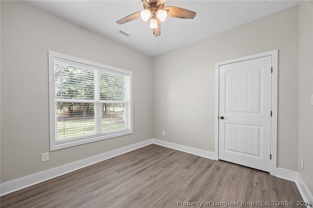 432 Pearidge Road Willow Spring, NC 27592 - Photo 22 of 47 a view of an empty room with wooden floor and a window