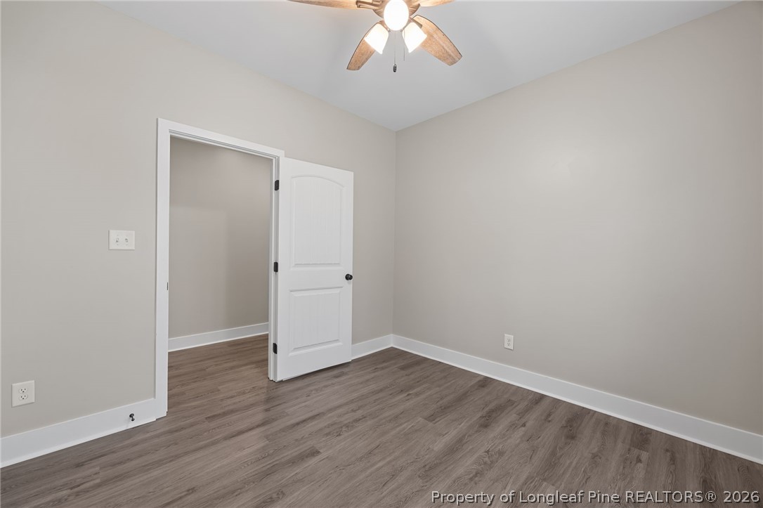 432 Pearidge Road Willow Spring, NC 27592 - Photo 23 of 47 an empty room with wooden floor and a ceiling fan