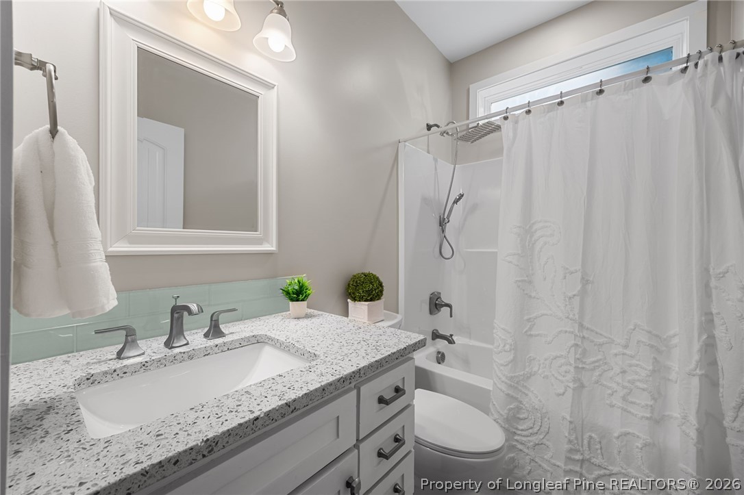 432 Pearidge Road Willow Spring, NC 27592 - Photo 25 of 47 a bathroom with a granite countertop sink toilet and shower