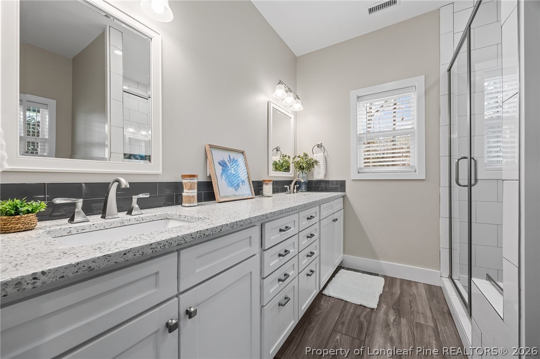 432 Pearidge Road Willow Spring, NC 27592 - Photo 28 of 47 a bathroom with a granite countertop sink mirror and a window