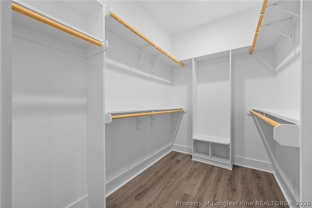 432 Pearidge Road Willow Spring, NC 27592 - Photo 30 of 47 a view of walk in closet with wooden floor