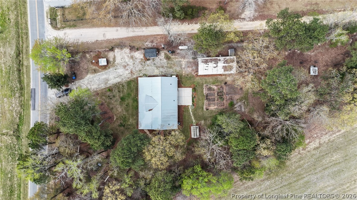 432 Pearidge Road Willow Spring, NC 27592 - Photo 42 of 47 a aerial view of a brick house with a yard and large tree