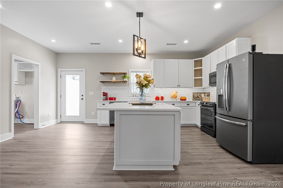432 Pearidge Road Willow Spring, NC 27592 - Photo 6 of 47 a kitchen with refrigerator cabinets and wooden floor