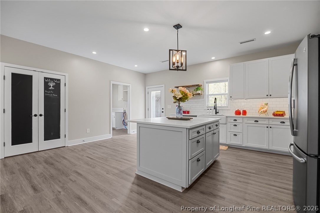 432 Pearidge Road Willow Spring, NC 27592 - Photo 7 of 47 a kitchen with stainless steel appliances a white wooden cabinets and window