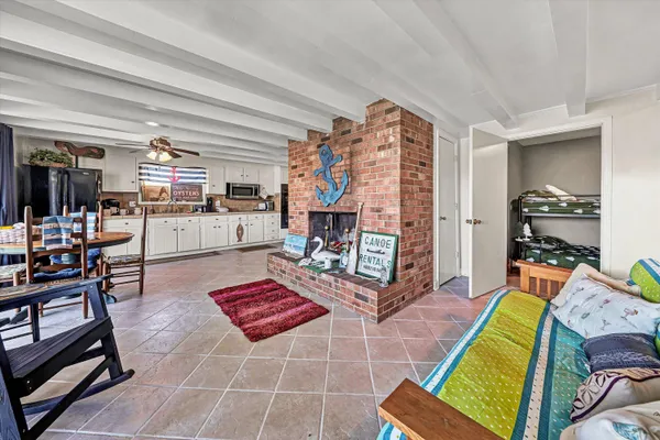 a view of a patio with table and chairs potted plants with wooden fence