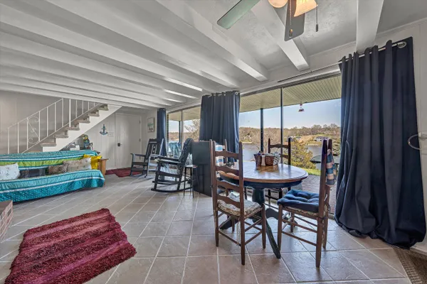a living room with furniture a large window and stainless steel appliances