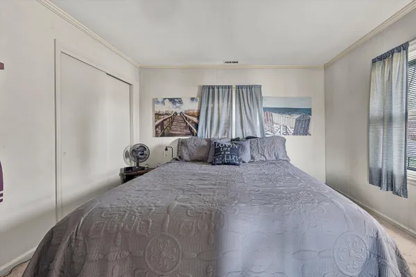 a bedroom with a bed and a dresser in it