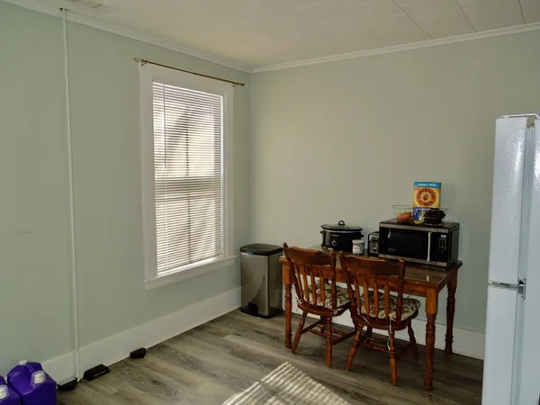 a view of a dining room with furniture and a window