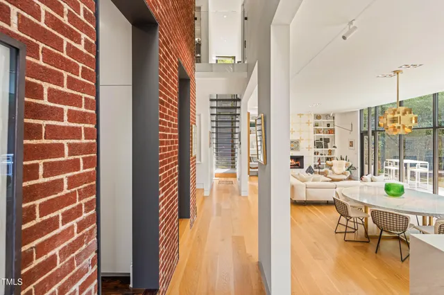 a room with lots of painting on the wall and a large window