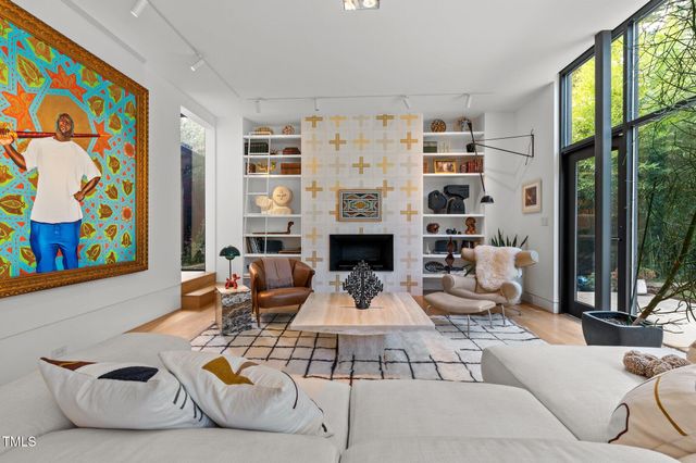 a living room with furniture and a floor to ceiling window