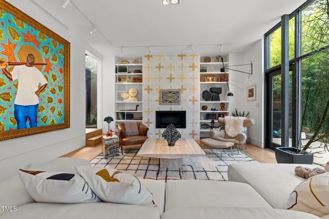 a living room with furniture and a floor to ceiling window