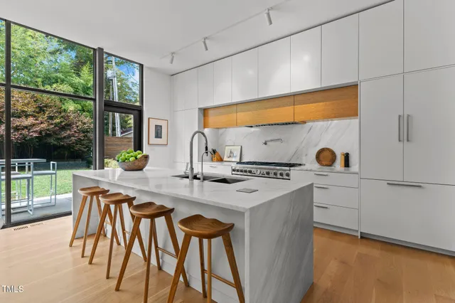 a living room with fireplace furniture and a large window