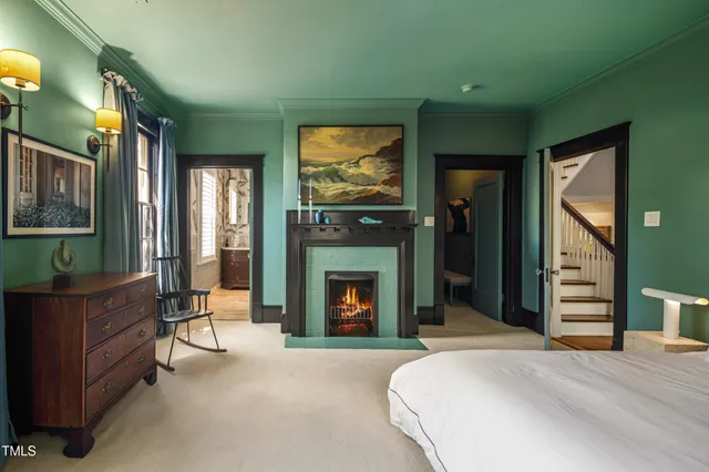 a bedroom with a bed and a fireplace