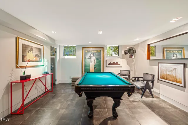 a living room with furniture a flat screen tv and a window
