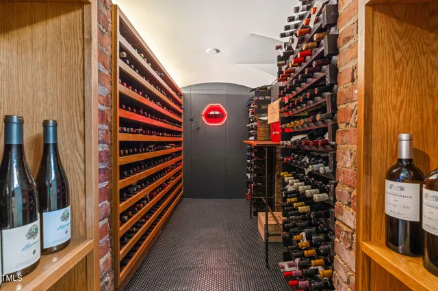 a view of a house with brick walls and a yard with plants