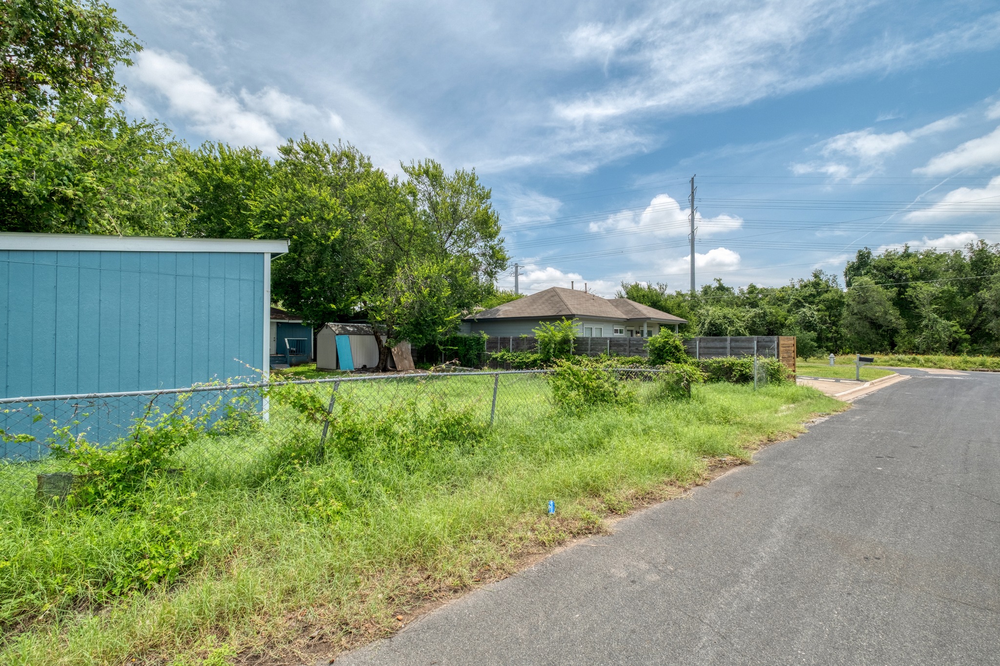 6409 Del Monte Road Austin, TX 78741 - Photo 9 of 15 A promising vacant lot awaits new construction, nestled beside a quiet residential street.