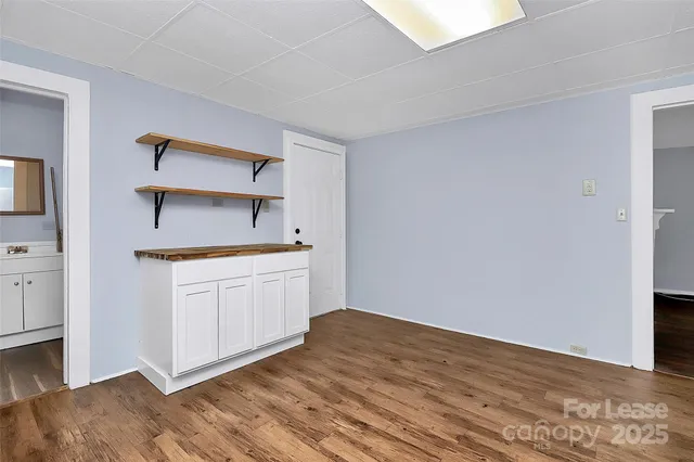 a kitchen with a sink cabinets and wooden floor