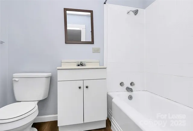 a bathroom with a sink a toilet and mirror