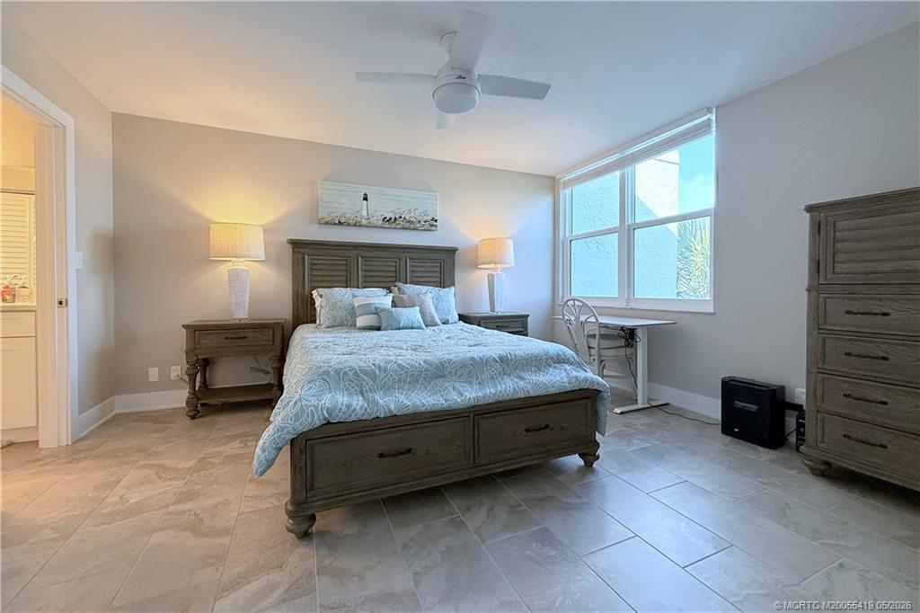 1950 Southwest Palm City Road, Unit 14305 Stuart, FL 34994 - Photo 33 of 70 a bedroom with a bed and a dresser