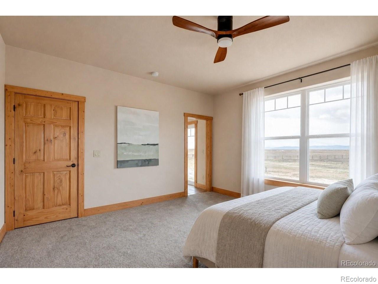 18298 Romar Rnch Road Carr, CO 80612 - Photo 20 of 49 a bedroom with a bed and window