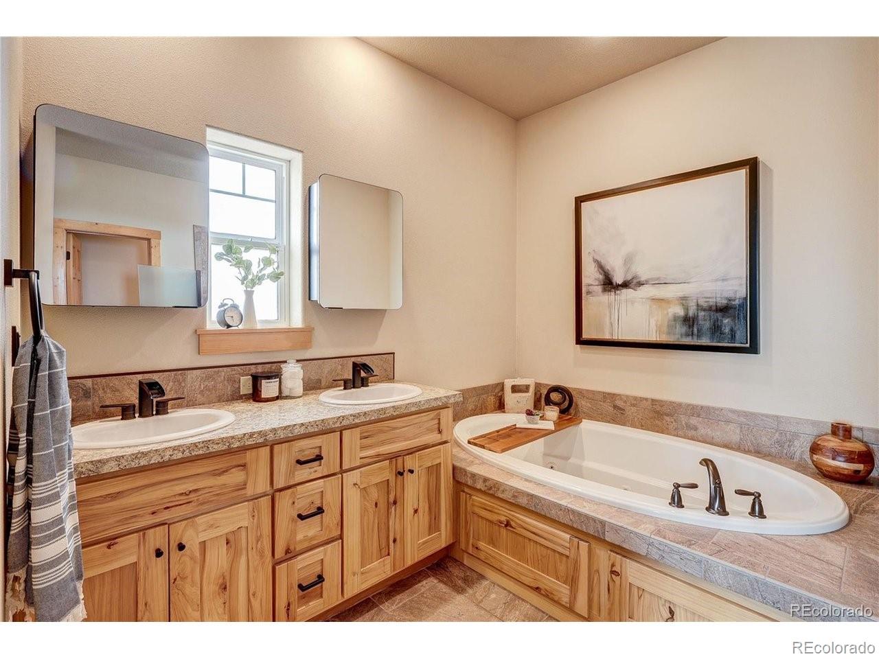 18298 Romar Rnch Road Carr, CO 80612 - Photo 21 of 49 a bathroom with a sink and a bathtub
