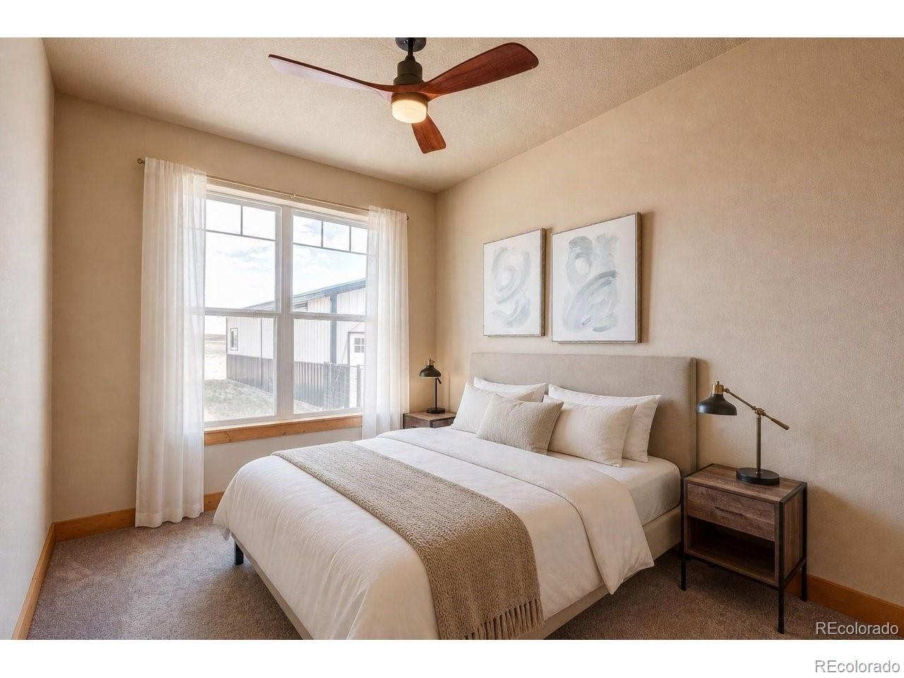 18298 Romar Rnch Road Carr, CO 80612 - Photo 25 of 49 a bedroom with a large bed and a window