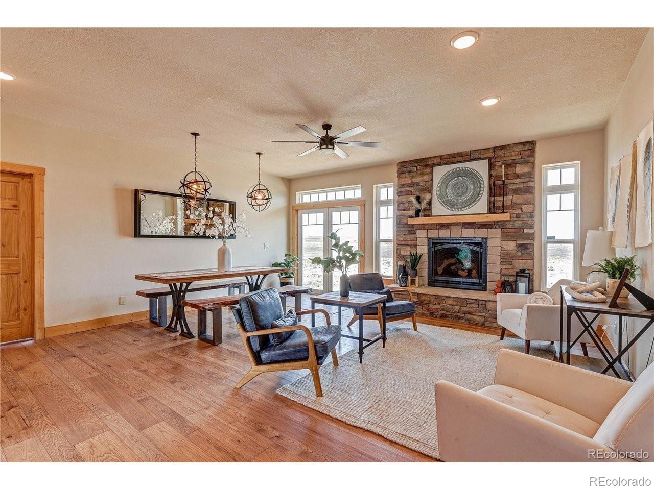 18298 Romar Rnch Road Carr, CO 80612 - Photo 26 of 49 a living room with furniture a fireplace and a large window
