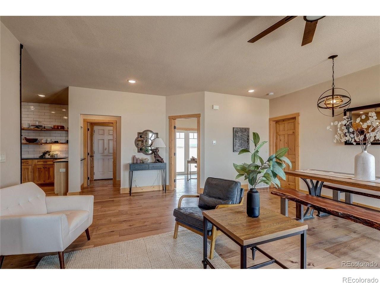 18298 Romar Rnch Road Carr, CO 80612 - Photo 29 of 49 a living room with furniture and wooden floor