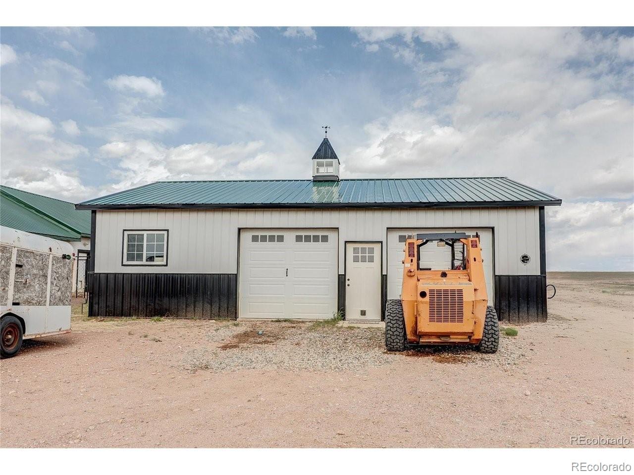 18298 Romar Rnch Road Carr, CO 80612 - Photo 40 of 49 a front view of a house with a yard and garage