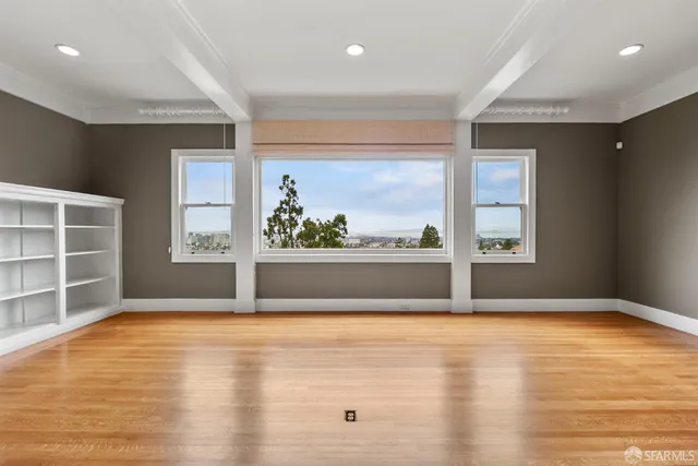 a kitchen with stainless steel appliances granite countertop a stove a sink dishwasher and white cabinets with wooden floor