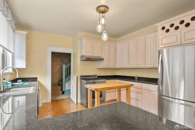 a view of an entryway with wooden floor and door