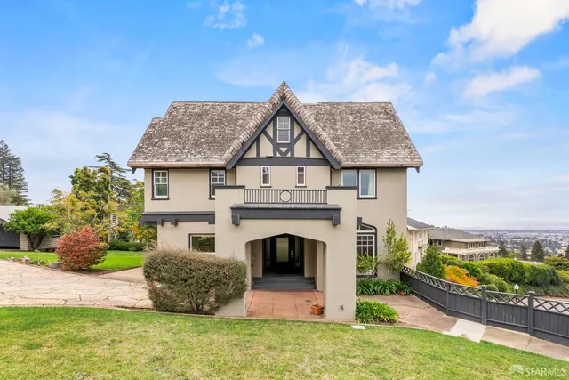 a front view of a house with a garden and plants