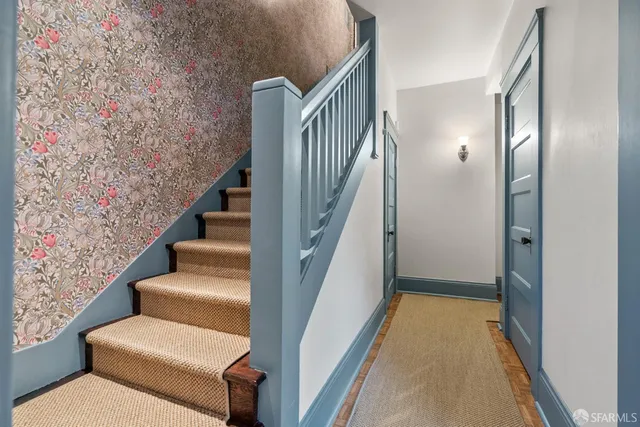 a bathroom with a granite countertop sink toilet and mirror