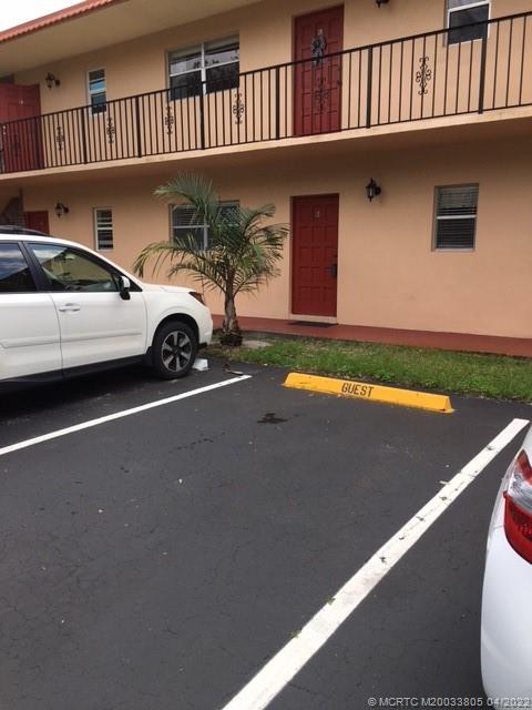 1913 Southwest Palm City Road, Unit 7B Stuart, FL 34994 - Photo 1 of 37 a view of a car park in front of a house
