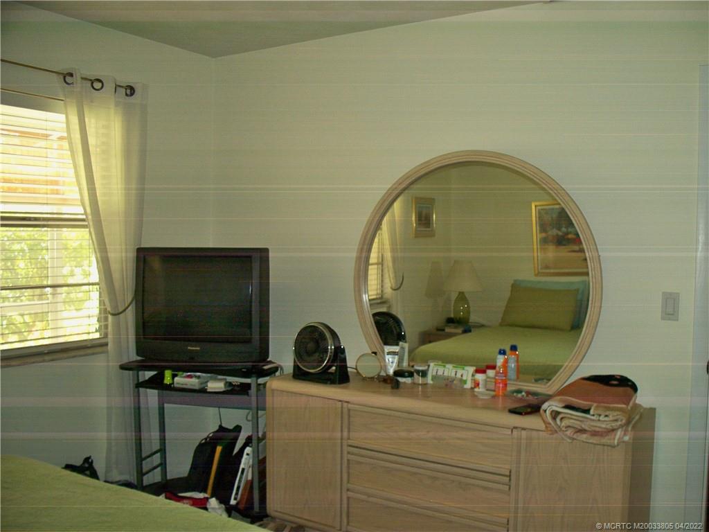 1913 Southwest Palm City Road, Unit 7B Stuart, FL 34994 - Photo 15 of 37 a room with a flat screen tv and a window