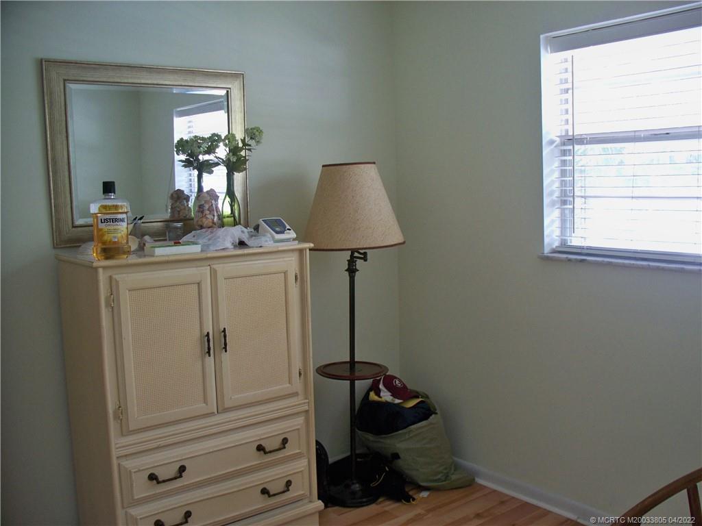1913 Southwest Palm City Road, Unit 7B Stuart, FL 34994 - Photo 19 of 37 a room with a dresser and a window