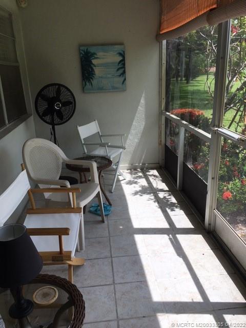 1913 Southwest Palm City Road, Unit 7B Stuart, FL 34994 - Photo 23 of 37 a living room with a couch and a table