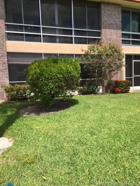 1913 Southwest Palm City Road, Unit 7B Stuart, FL 34994 - Photo 27 of 37 a view of a house with a garden